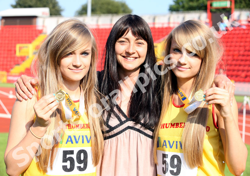 Former Great Britain and England 400 metres athlete Angela Piggford with her twin daughters Emma (left) and Jenny after being members of the Junior Girls 4x100 metres team who won the gold medal at the 2011 Aviva English Schools' 81st Track and Field Championships, Gateshead International Stadium